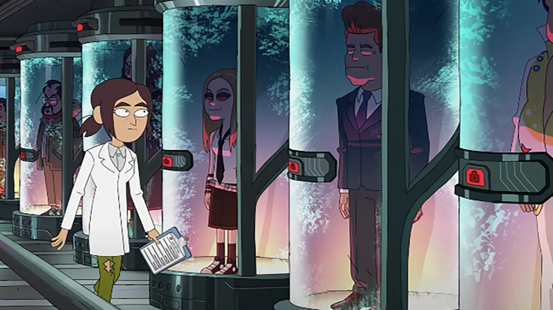 woman walks by clone vats inside job