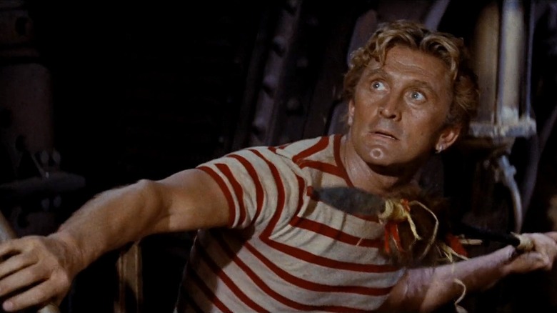 Ned Land (Kirk Douglas) looks up holding a spear in 20,000 Leagues Under the Sea