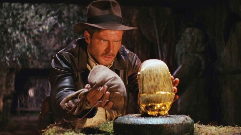 Indiana Jones (Harrison Ford) prepares to swap a bag for a golden idol in Raiders of the Lost Ark