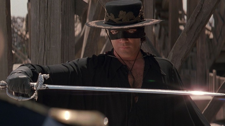 Alejandro Murrieta (Antonio Banderas) draws a sword while dressed as Zorro in The Mask of Zorro