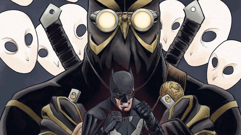 Batman stands in front of a Talon from Court of Owls