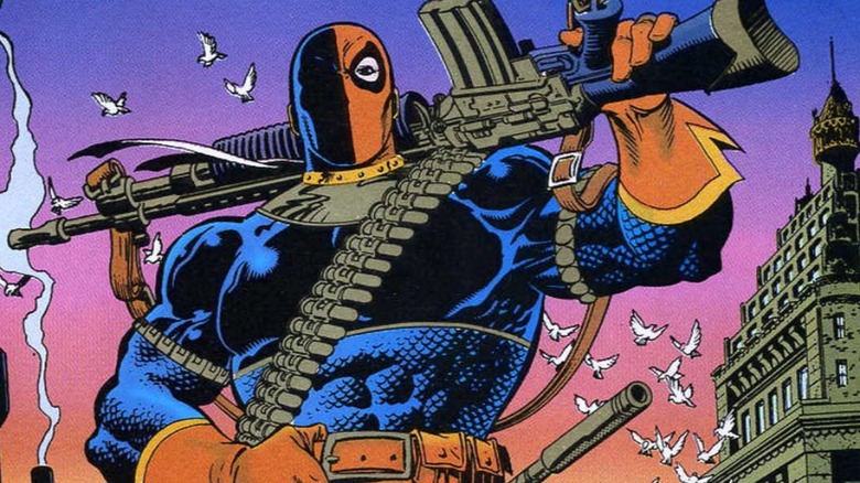 Deathstroke holds a gun over his shoulders