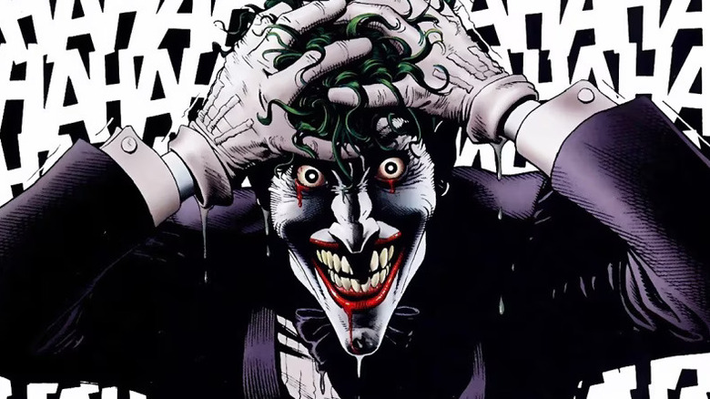 The Joker laughing with hands over his head