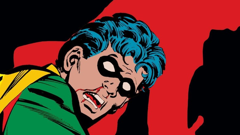 Joker beats up Jason Todd with a crowbar