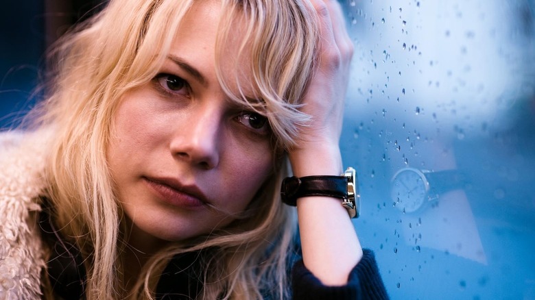 Michelle Williams as Cindy leaning against a rainy window in Blue Valentine
