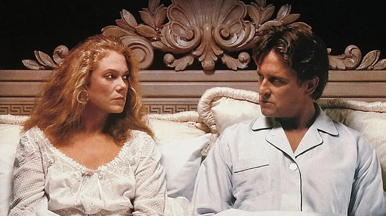 Kathleen Turner and Michael Douglas as Barbara and Oliver in bed in War of the Roses