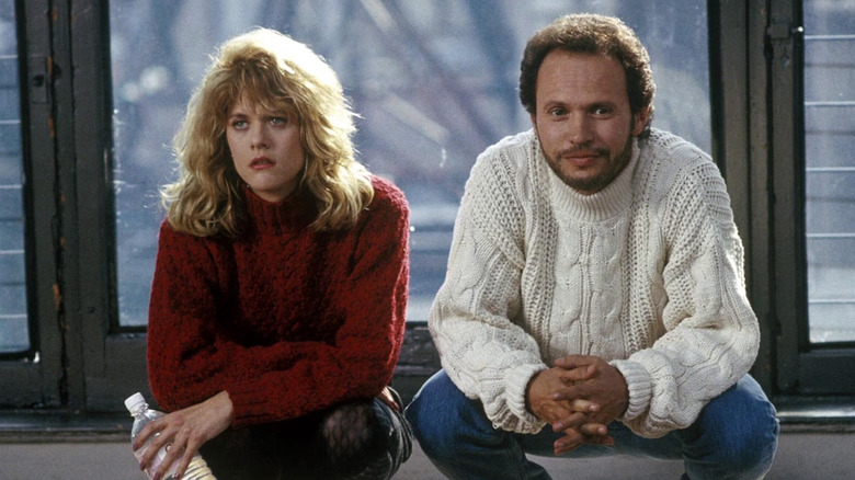 Meg Ryan and Billy Crystal as Sally and Harry crouching in sweaters in When Harry Met Sally...