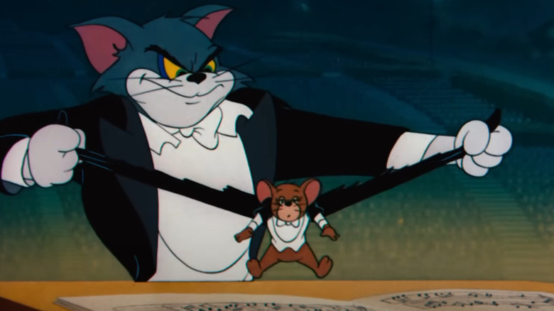 Tom rips Jerry's tuxedo coat in the middle of a classic concert in Tom & Jerry