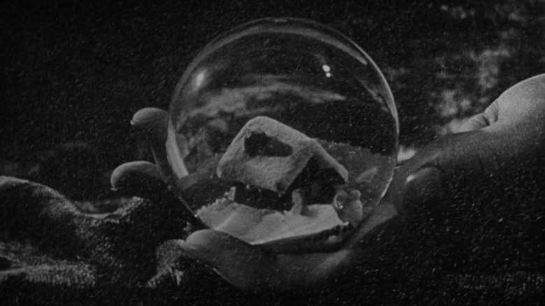Charles Foster Kane (Orson Welles) holds a snow globe in Citizen Kane