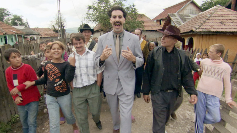 Sacha Baron Cohen as Borat walking with villagers in Borat: Cultural Learnings of America for Make Benefit Glorious Nation of Kazakhstan