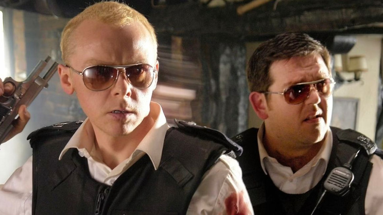 Simon Pegg as Nicholas Angel stands next to Nick Frost as Danny in Hot Fuzz