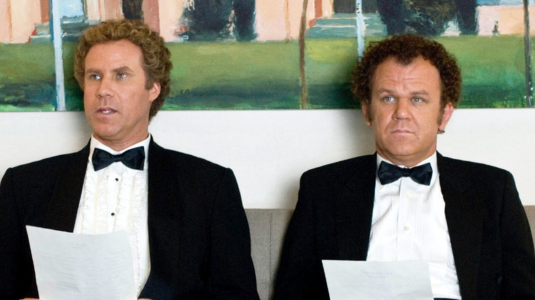 Will Ferrell as Brennan Huff sits in a tuxedo next to John C. Reilly as Dale Doback in Step Brothers