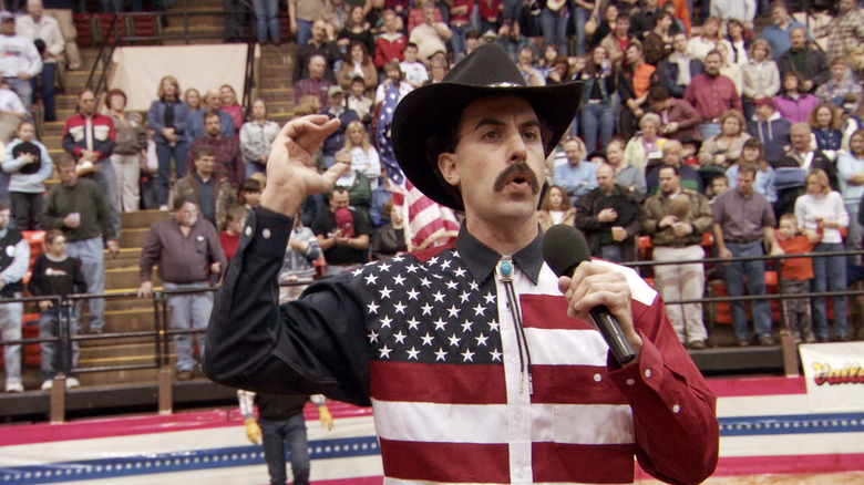 Borat (Sacha Baron Cohen) sings to an unwitting rodeo crowd in Borat