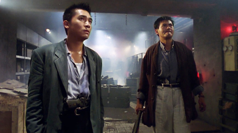 Alan (Tony Leung) and Tequila Yuen (Chow Yun-fat) stand next to each other looking up in a service area in Hard Boiled
