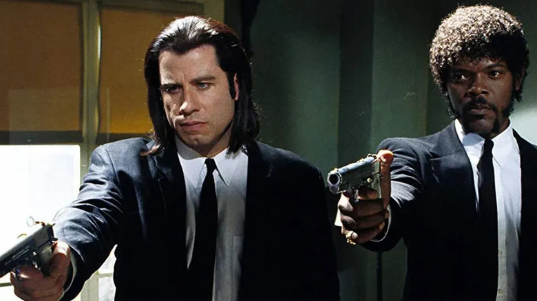 Vincent Vega (John Travolta) and Jules Winnfield (Samuel L. Jackson) aim pistols side-by-side in Pulp Fiction