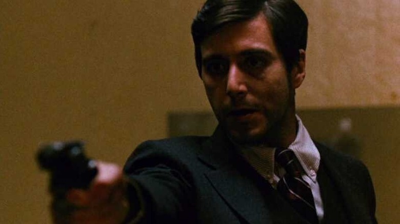 Michael Corleone (Al Pacino) aims a pistol in The Godfather