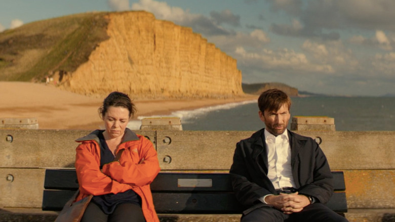 Ellie Miller (Olivia Colman) and Alec Hardy (David Tennant) sit unhappily on a bench overlooking the coast in Broadchurch