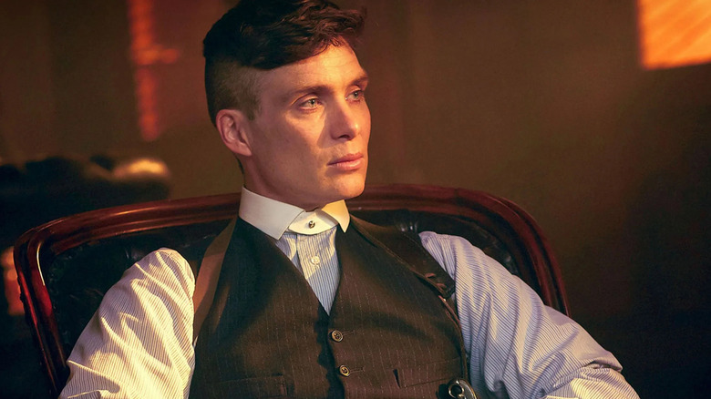 Tommy Shelby (Cillian Murohy) sits in an armchair in Peaky Blinders