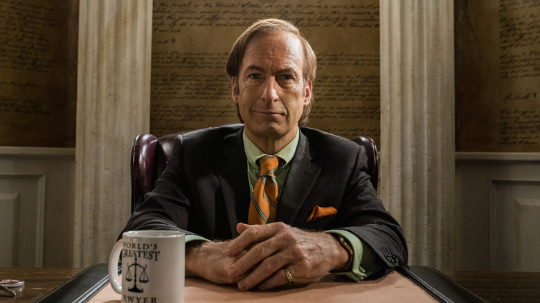 Bob Odenkirk as Saul Goodman, sitting behind his desk on Better Call Saul
