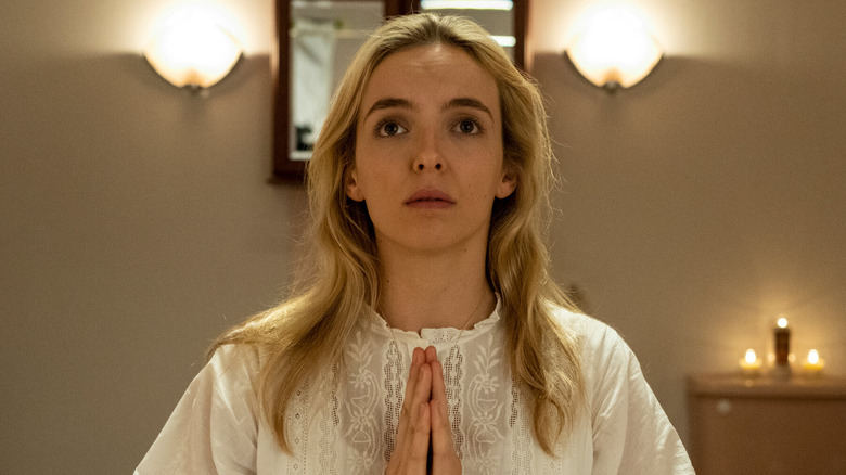 Jodie Comer as Villainelle, praying on Killing Eve