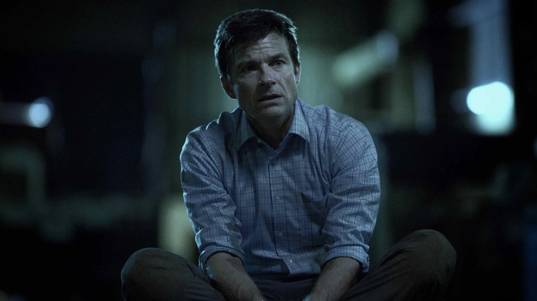 Jason Bateman as Marty Byrde, sitting on the ground on Ozark