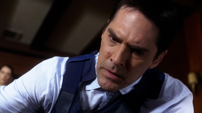 Thomas Gibson as Aaron Hotchner, kneeling over a body on Criminal Minds