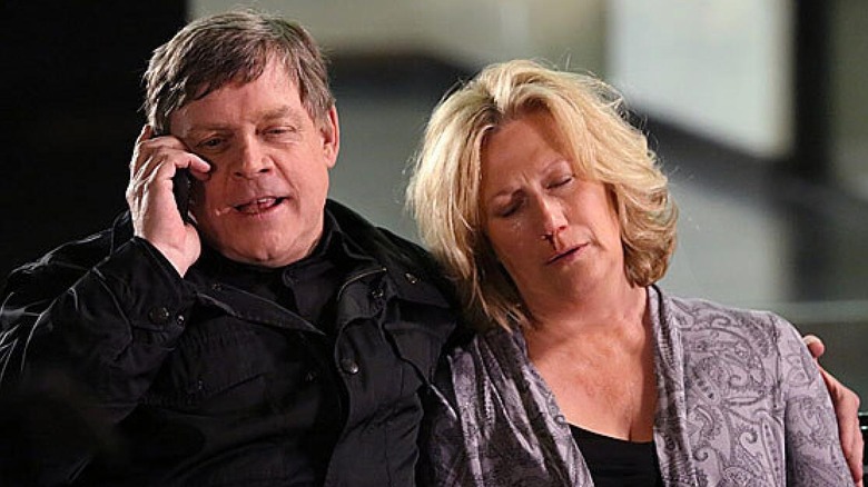 Mark Hamill and Jayne Atkinson as John Curtis and Erin Strauss sitting on a bench together on Criminal Minds