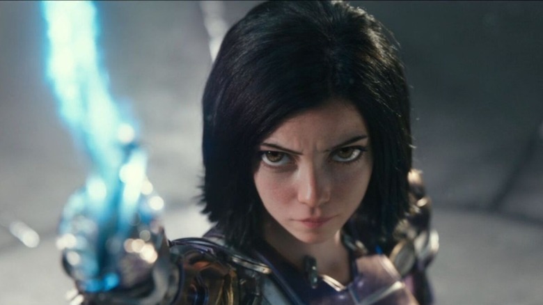 Alita (Rosa Salazar) holds up a glowing sword in Alita: Battle Angel