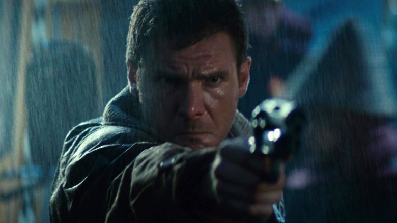 Deckard (Harrison Ford) aims a gun in Blade Runner