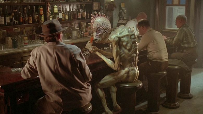 Bill Lee (Peter Weller) talks to an alien creature at a bard in Naked Lunch