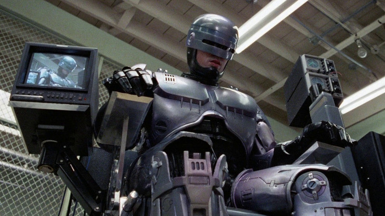Robocop (Peter Weller) sits in a high-tech chair