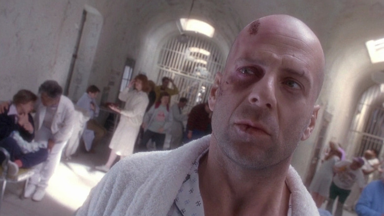 James Cole (Bruce Willis) looks scared in a mental hospital in 12 Monkeys