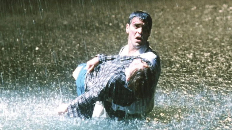 George Clooney as Doug carrying boy in water in pouring rain in ER