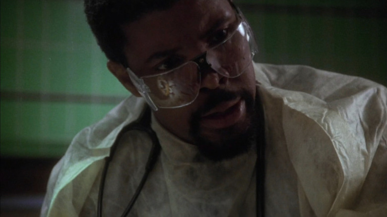 Close-up of Eriq La Salle as Benton looking surprised in the OR in ER