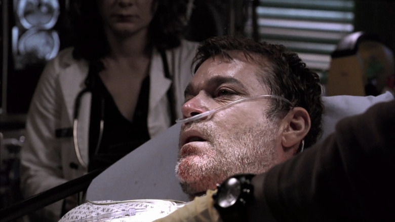 Ray Liotta as Charlie Metcalf in hospital bed with out of frame doctors beside him in ER
