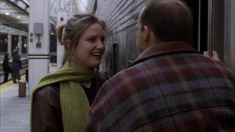 Anthony Edwards as Mark Greene facing away from camera talking to Sherry Stringfield as Susan at train station in ER