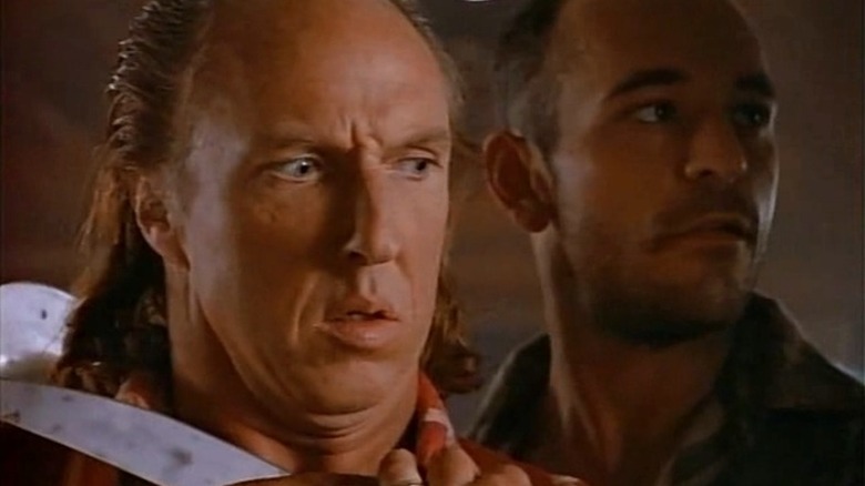 Steve has a knife held to his throat in Tales from the Crypt