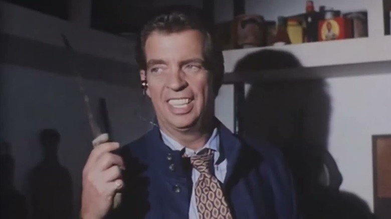 Horton holds up a knife in Tales from the Crypt