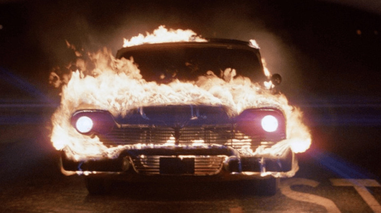 Christine glows menacingly while engulfed in flames in Christine