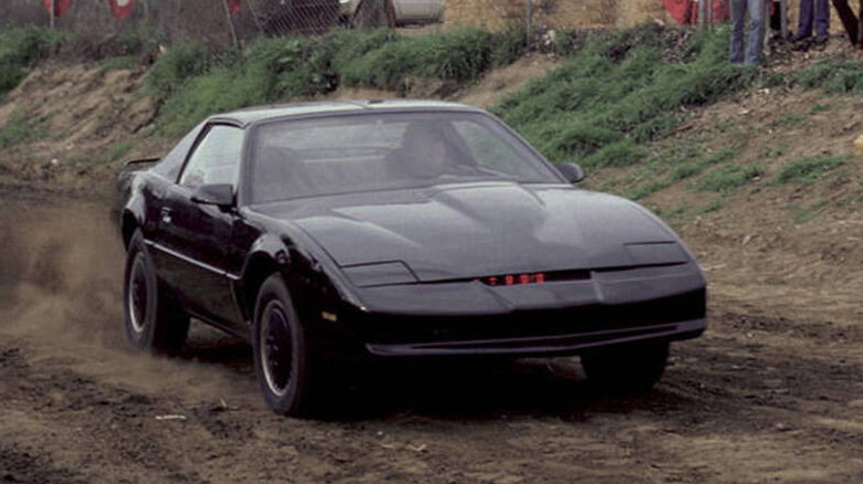 KITT drives along a dirt road in Knight Rider (1982)