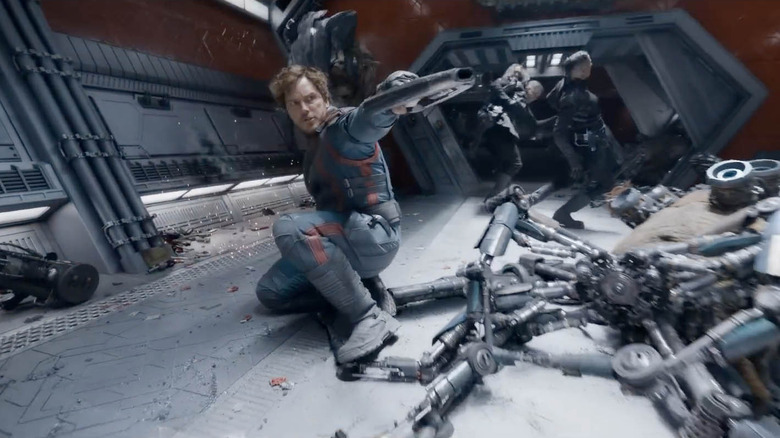 Star-Lord (Chris Pratt) pointing blaster at enemies in Guardians of the Galaxy Vol. 3