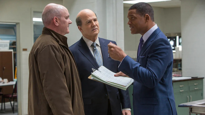 Bennet Omalu (Will Smith) confronts Daniel Sullivan (Mike O'Malley) and Cyril Wecht (Albert Brooks) with his finding in Concussion (2015)