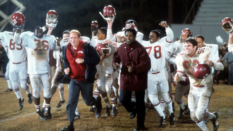 Herman Boone (Denzel Washington) and Bill Yoast (Will Patton) celebrating with the team in Remember the Titans