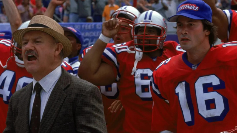 Jimmy McGinty (Gene Hackman) shouts from the sidelines with his team next to Shane Falco (Keanu Reeves) in The Replacements