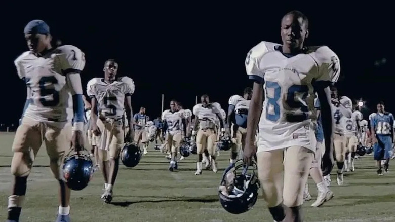 A high school football team walks solemnly off the field in Undefeated (2011)