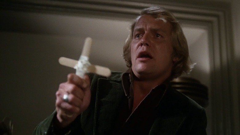 David Soul as Ben, warding off a vampire in Salem's Lot