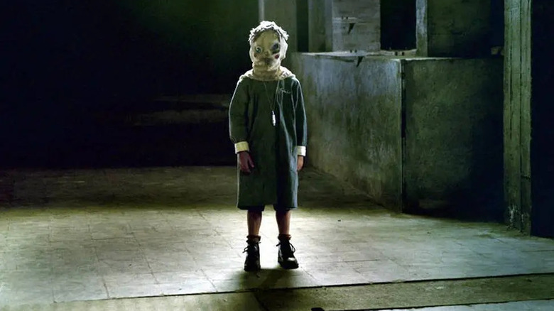a masked child named Tomas, intentionally freaking everyone out in The Orphanage