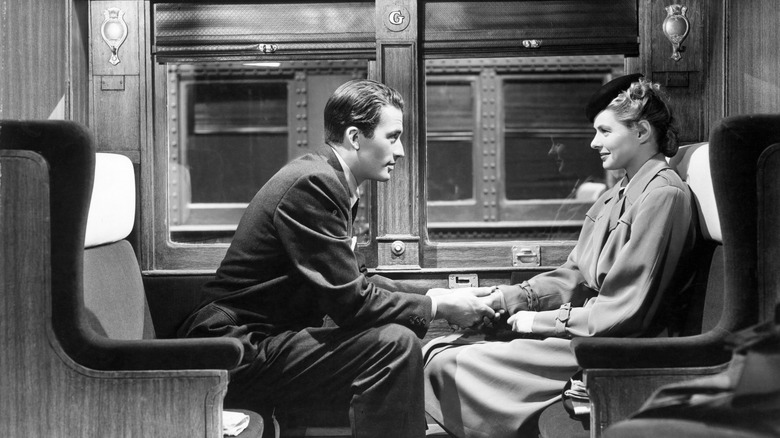 Peck holding Bergman's hand on train