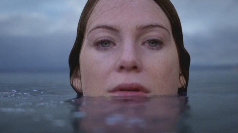 Ellen Pompeo as Dr. Meredith Grey submerged in sea water up to her chin on Grey's Anatomy