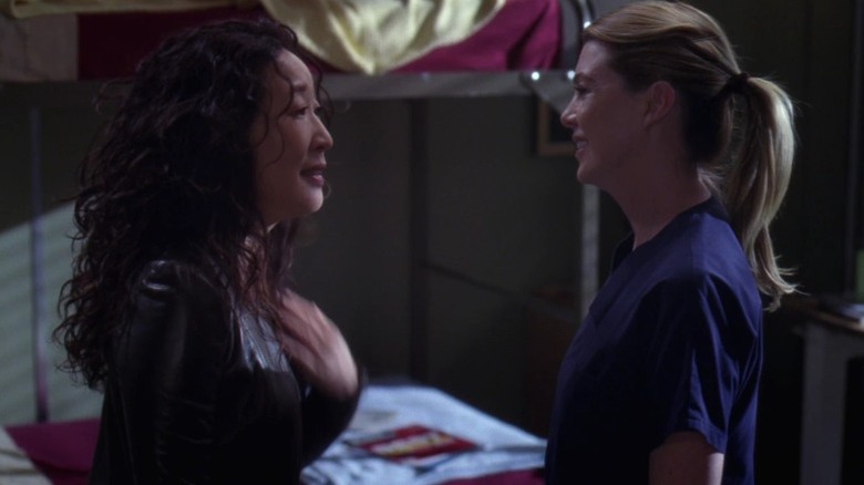 Sandra Oh as Dr. Cristina Yang and Ellen Pompeo as Dr. Meredith Grey smiling at each other on Grey's Anatomy